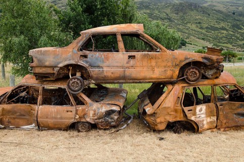 Stack of three rusty car wrecks