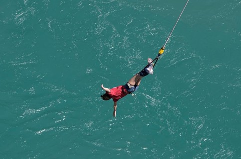 Bungee jumper on the rope over Kawarau River