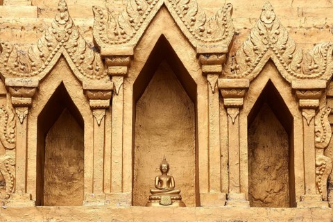 Small Buddha statue in a niche of the Wat Jong Kham