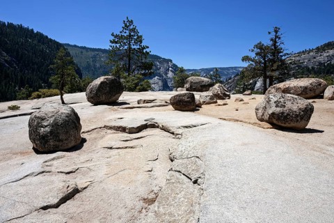Round granite rocks on a granite surface