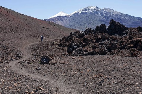 Hiker in volcanic landscape
