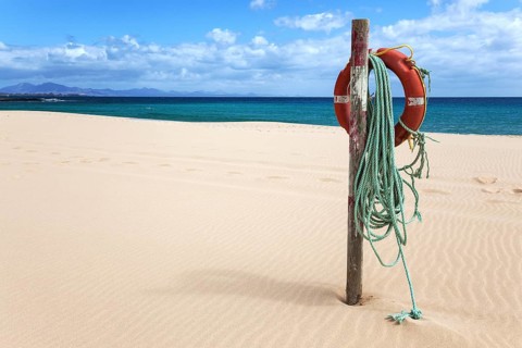 Lifebuoy on the sandy beach Playa Bajo Negro