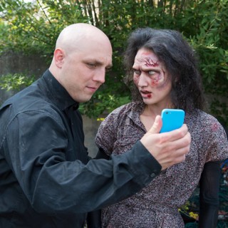 Zombie and man with smartphone