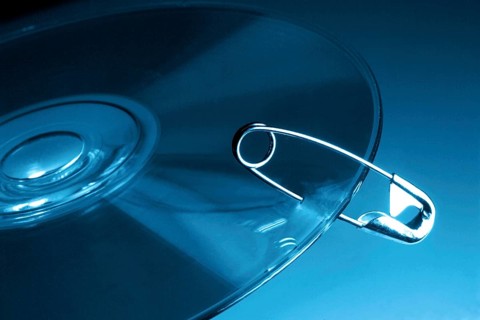 CD-ROM symbolically fastened with safety pin