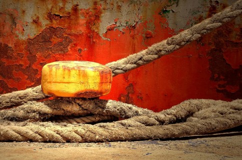 Yellow bollard with ropes wrapped around