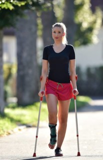Young woman with crutches