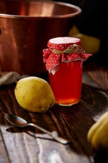 Quince jelly and fruit on wooden table
