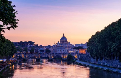 Saint Peter's Basilica with Sant' Angelo's Bridge over Tiber at sunset