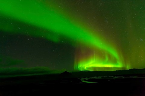 Northern lights over river delta