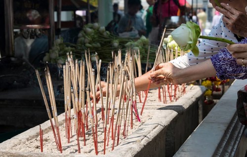 Believers lighting incense sticks