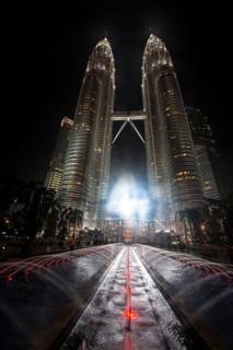 Fountain in front of illuminated Petronas Twin Towers at night