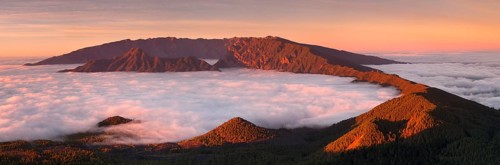 Cumbre Nueva and Cumbre Vieja mountains at sunset above clouds