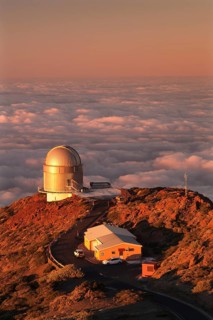 Observatory on the Roque de los Muchachos with clouds at sunset