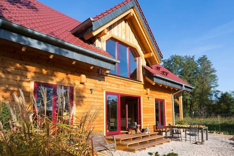 Modern log house made of larch with terrace