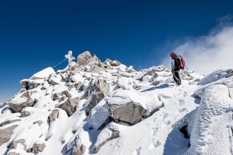 Mountaineer climbing the Loffler in snow at the summit