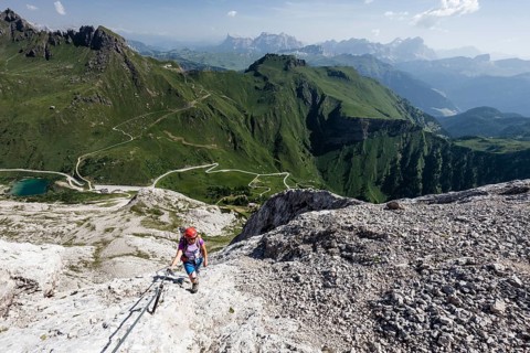 Mountaineer ascending to the Punta Serauta on the Via Ferrata Eterna in Marmolada