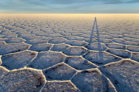 Photographer's shadow on honeycomb structure of Salar de Uyuni