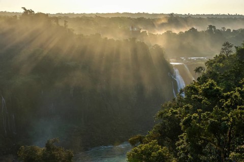View from the waterfall Salto Santa Maria over the rainforest of Isla San Martin at sunset