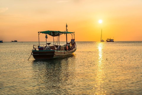 Fishing boat in the sea at sunset