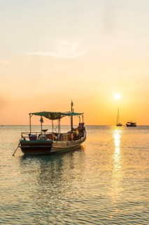 Fishing boat in the sea at sunset