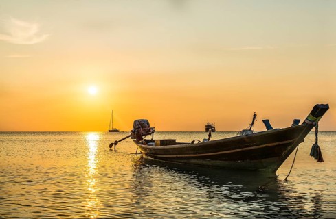 Longtail boat in the sea at sunset