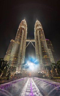 Fountain in front of the illuminated Petronas Tower at night