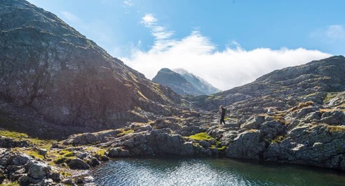 Hiker by a mountain lake