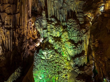 Stalactites in the colorfully lit cave Cuevas de Nerja