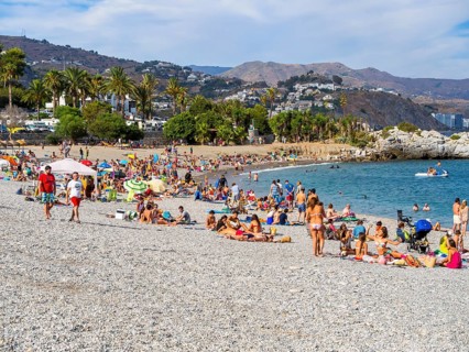 Bathers on the pebble beach of La Herradura