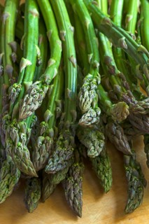 Fresh green asparagus on a wooden board