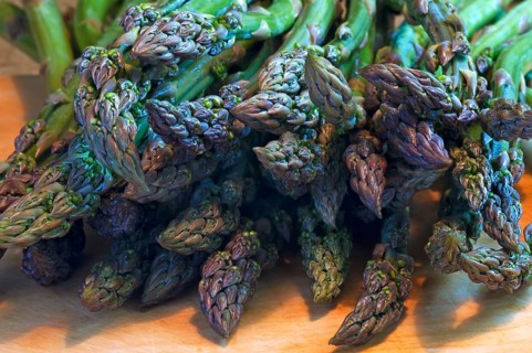 Fresh green asparagus on a wooden board