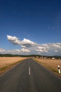 Road between mown down fields