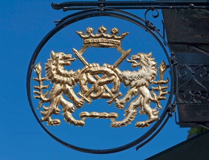 Bakery signboard with lions and pretzel