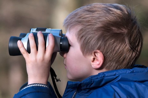 Boy looking through binoculars