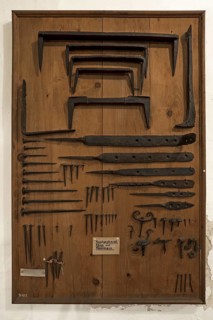 Board with hand-forged nails and staples