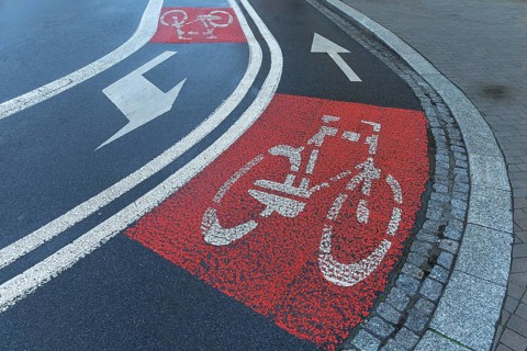 Red marked bicycle paths on the roadway