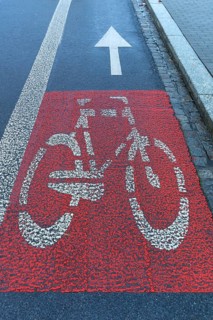 Red marked bicycle path on the roadway