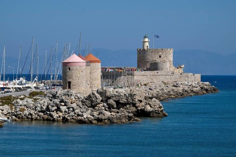 Windmills and Agios Nikolaos fortress at Mandrake harbor