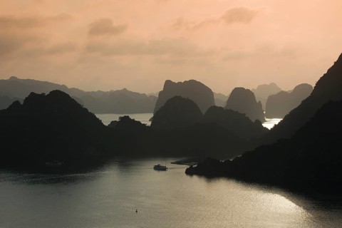 Boat on the water at sunset in the Ha Long Bay or Vinh Ha Long