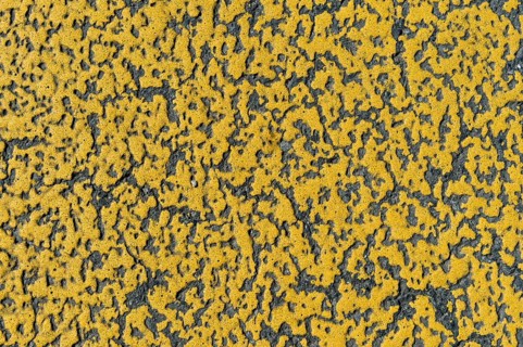 Yellow paint on asphalt