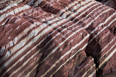 Limestone coloured red by iron and whitish-yellow dolomite