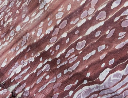 Limestone coloured red by iron and whitish-yellow dolomite
