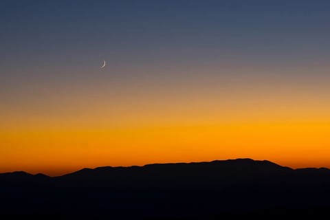 Sunset and crescent moon over the Sibillini Mountains