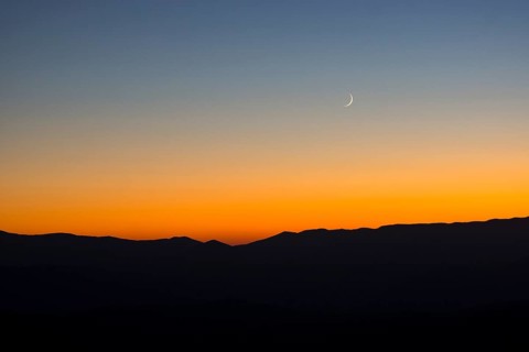 Sunset and crescent moon over the Sibillini Mountains