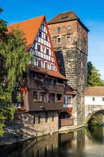 Old half-timbered house and water tower by the river Pegnitz