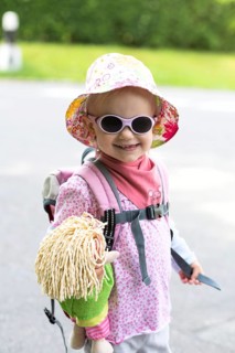 Toddler hiking with doll