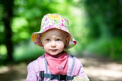 Toddler hiking through the woods
