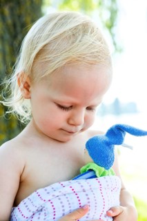 Toddler holding a small doll