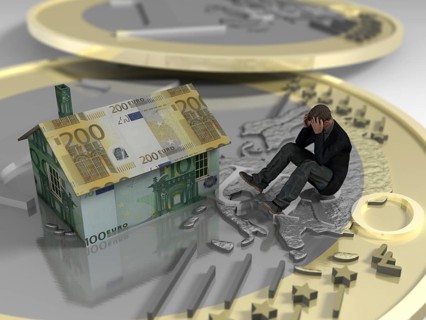 Man sitting on euro coin next to house made of banknotes