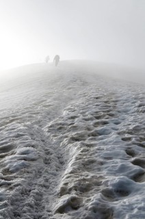 Climbers fading away in the fog